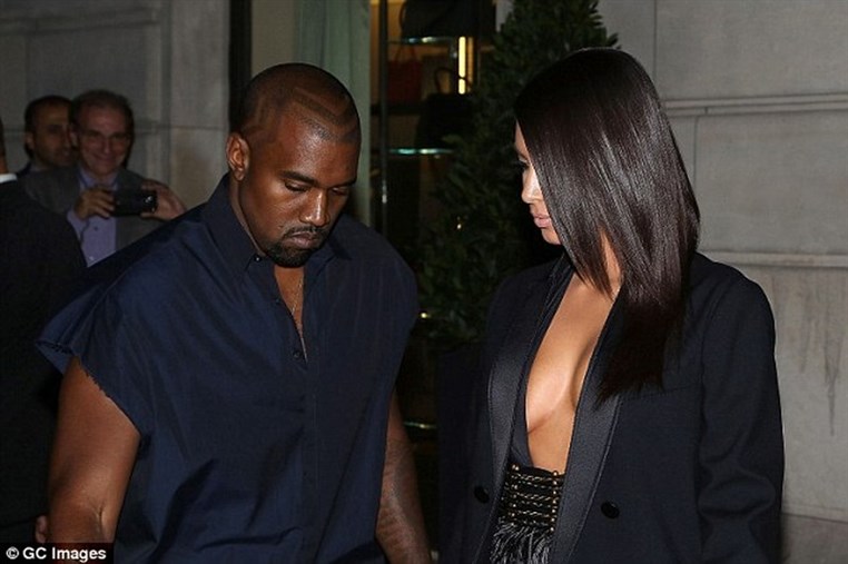 Kim Kardashian appears topless under open tuxedo jacket  